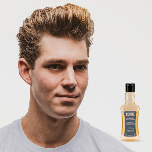 MAN WITH Cleanly shaved face using REUZEL Wood & Spice Aftershave
