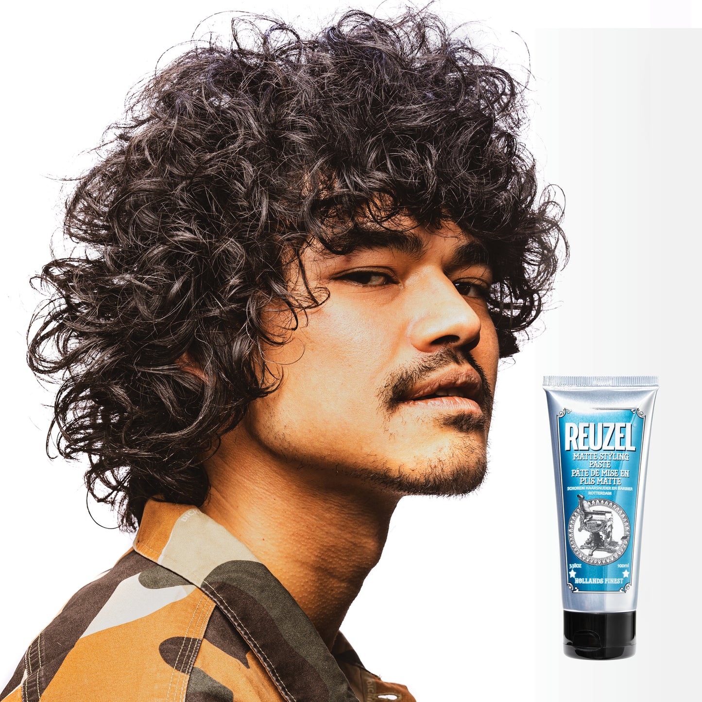 Reuzelinc grooming cream jar with a black lid and label, showing the product inside, suitable for styling and grooming hair.