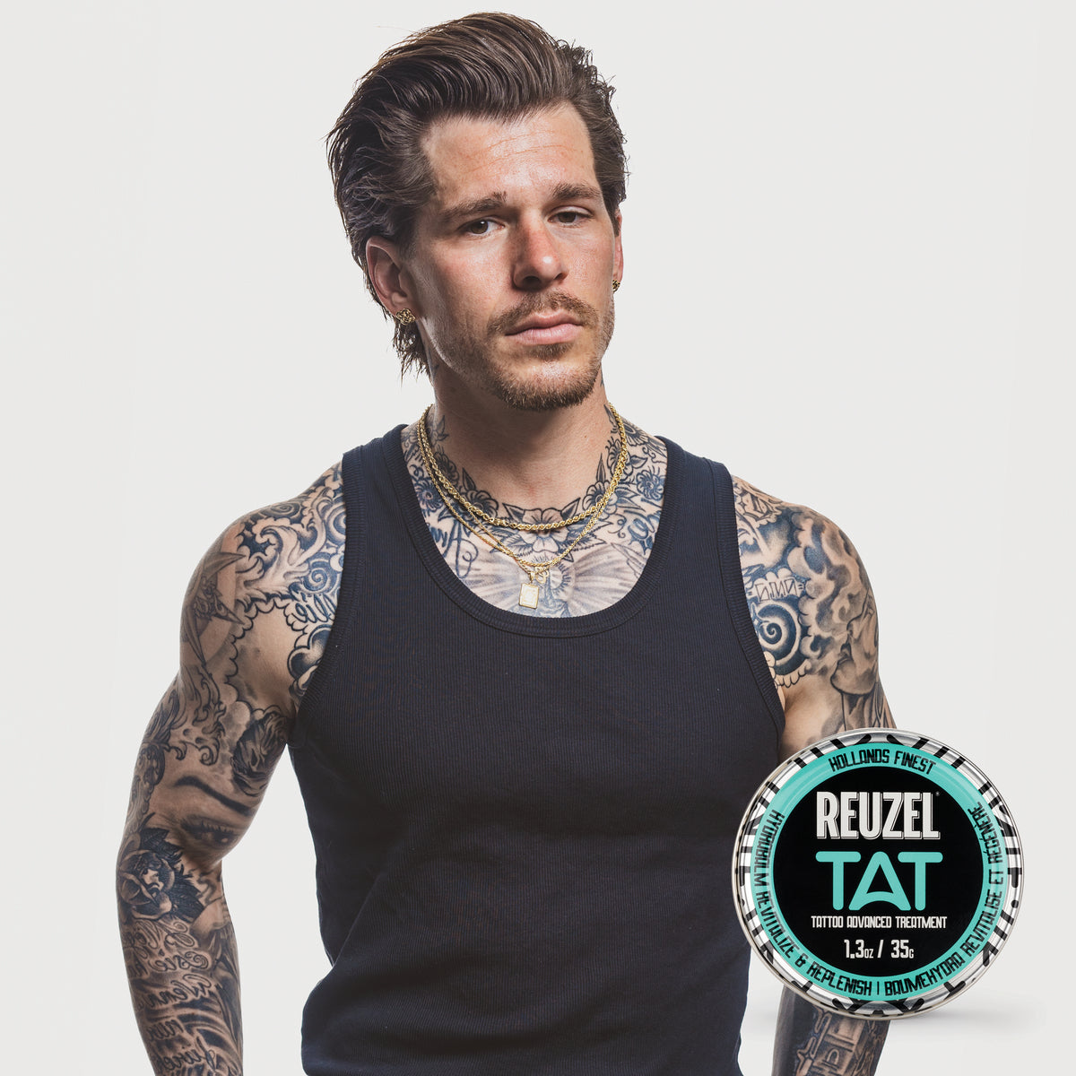 Male model with short brown hair and tattoos next to REUZEL hydrabalm