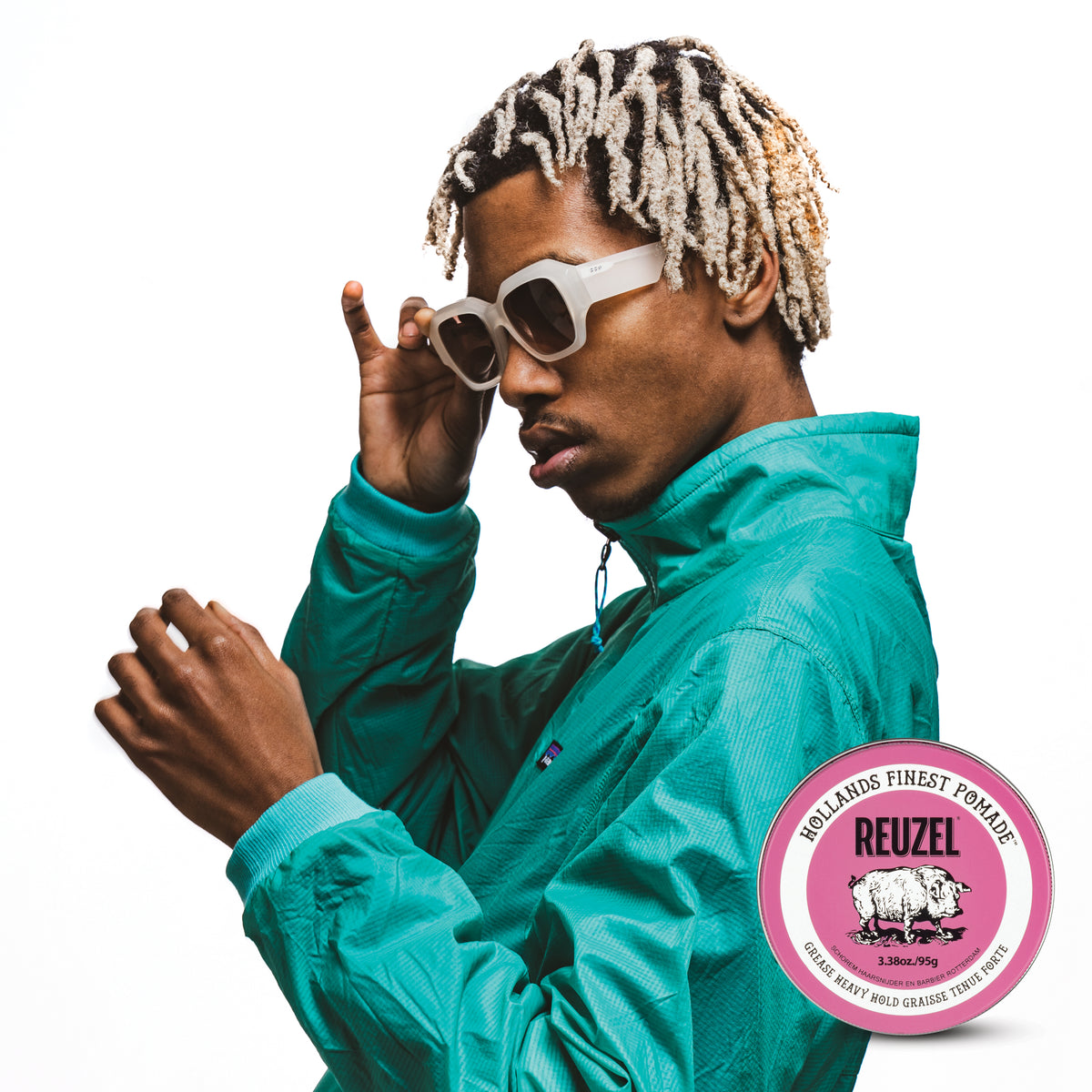 Male model with bleached dreadlocks and next to REUZEL pink pomade grease heavy hold