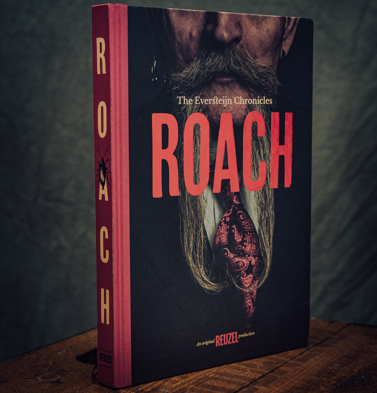 Open copy of the ROACH book by Vendor showing pages and cover, with a focus on the book's title and design details.