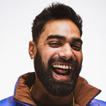 Man with well-groomed full beard smiling, showing results of quick daily beard care routine