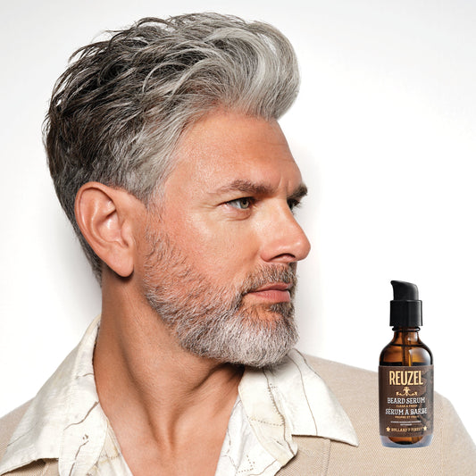 Male model with grey hair and beard next to REUZEL Beard Oil