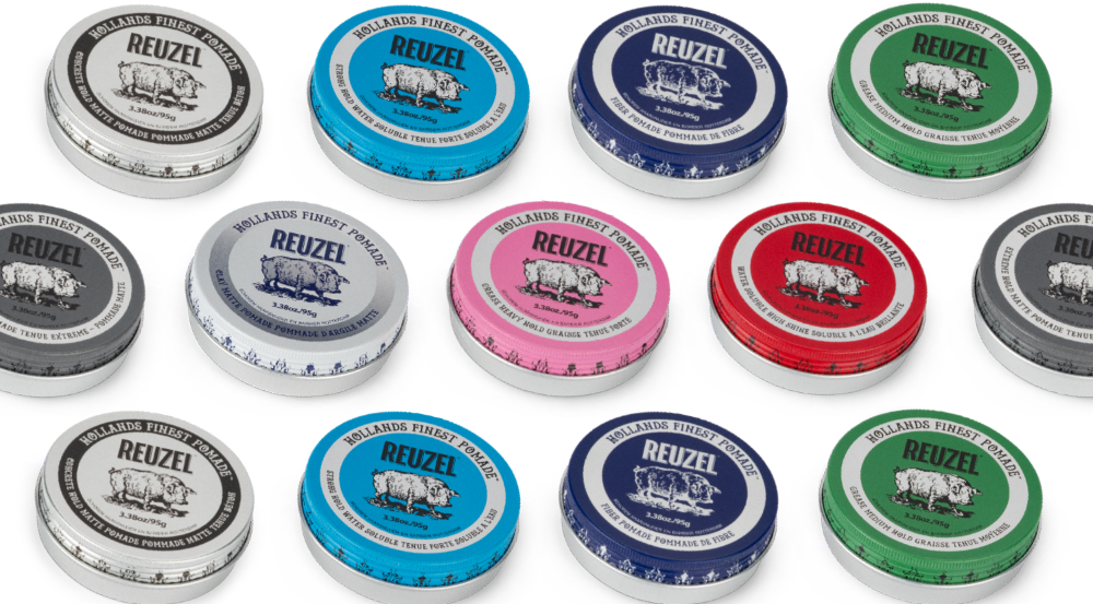 All REUZEL pomade tins displayed together, showing the full range of tin colors and formulas used to compare hold strength, shine level, and hair type suitability.