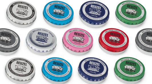 All REUZEL pomade tins displayed together, showing the full range of tin colors and formulas used to compare hold strength, shine level, and hair type suitability.