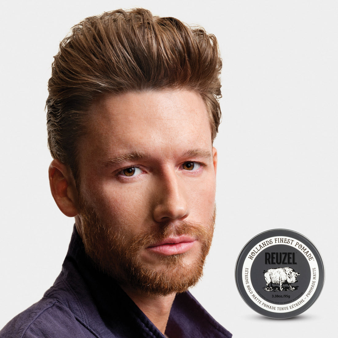 Man with a short hairstyle with a matte finish, featuring REUZEL Extreme Pomade