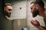 Man applying beard oil in winter 2026 to prevent dryness and beard dandruff
