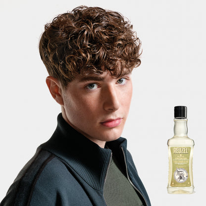 Man with brown hair washed with REUZEL 3 IN 1 SHAMPOO