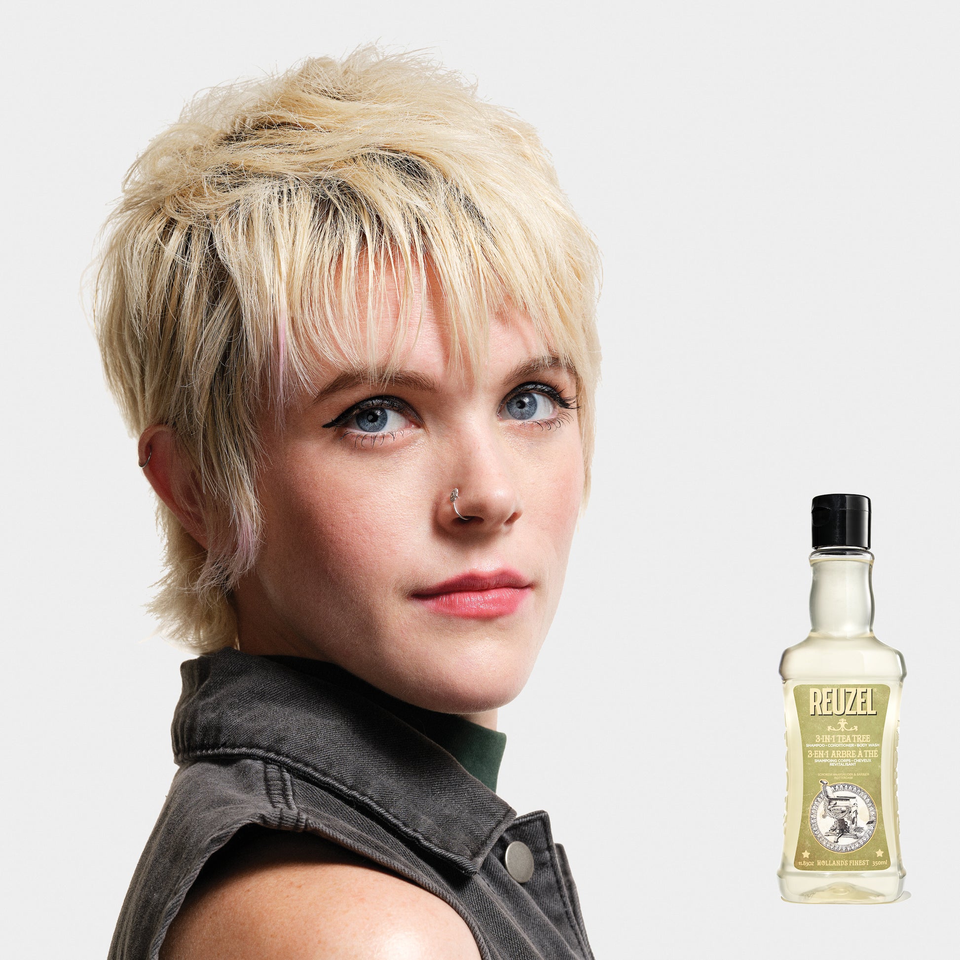 Woman with blonde hair washed with REUZEL 3 IN 1 SHAMPOO