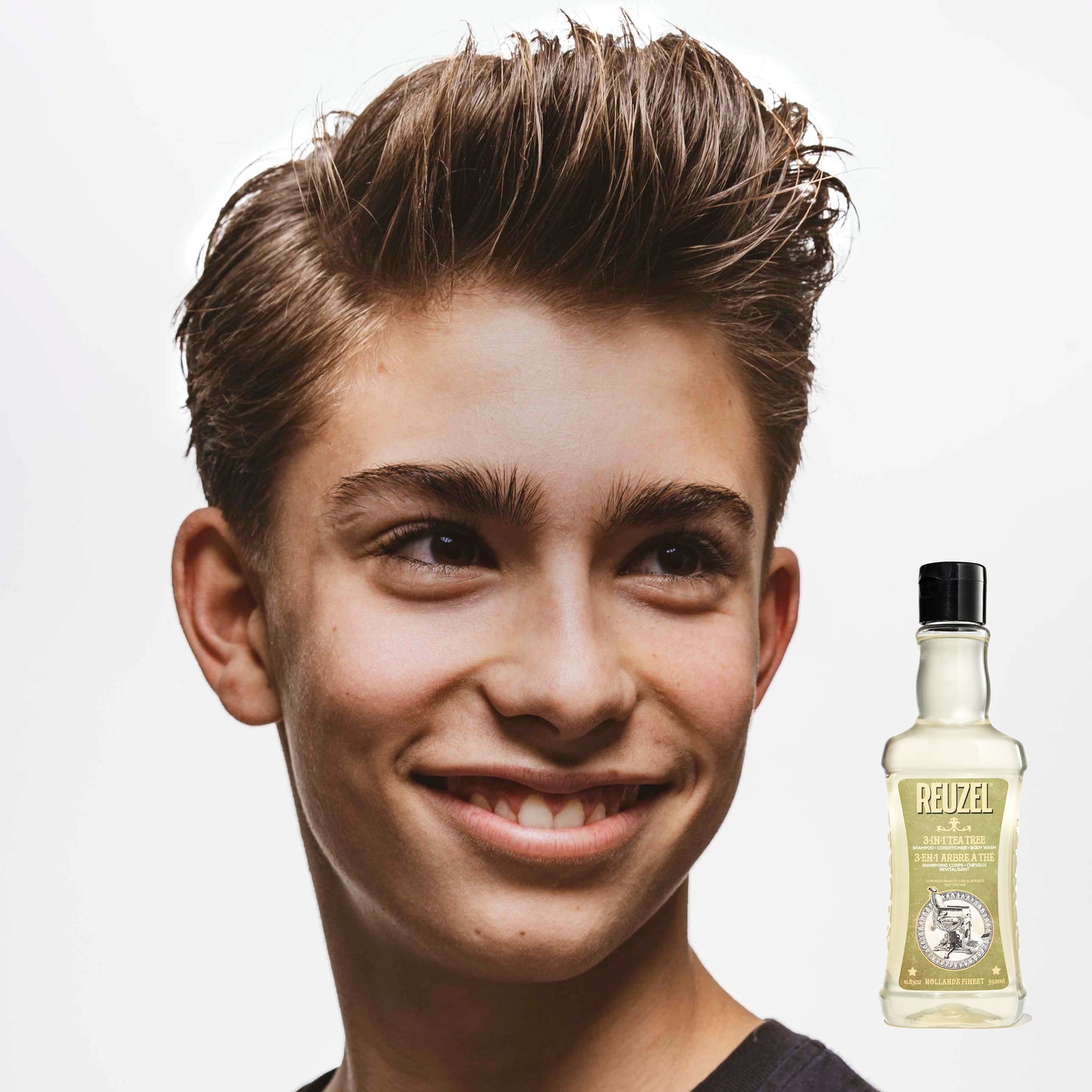 Boy with brown hair washed with REUZEL 3 IN 1 SHAMPOO