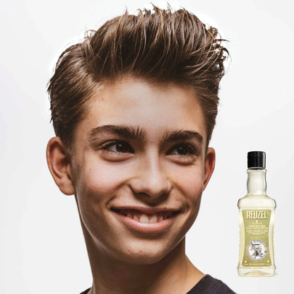 Boy with brown hair washed with REUZEL 3 IN 1 SHAMPOO