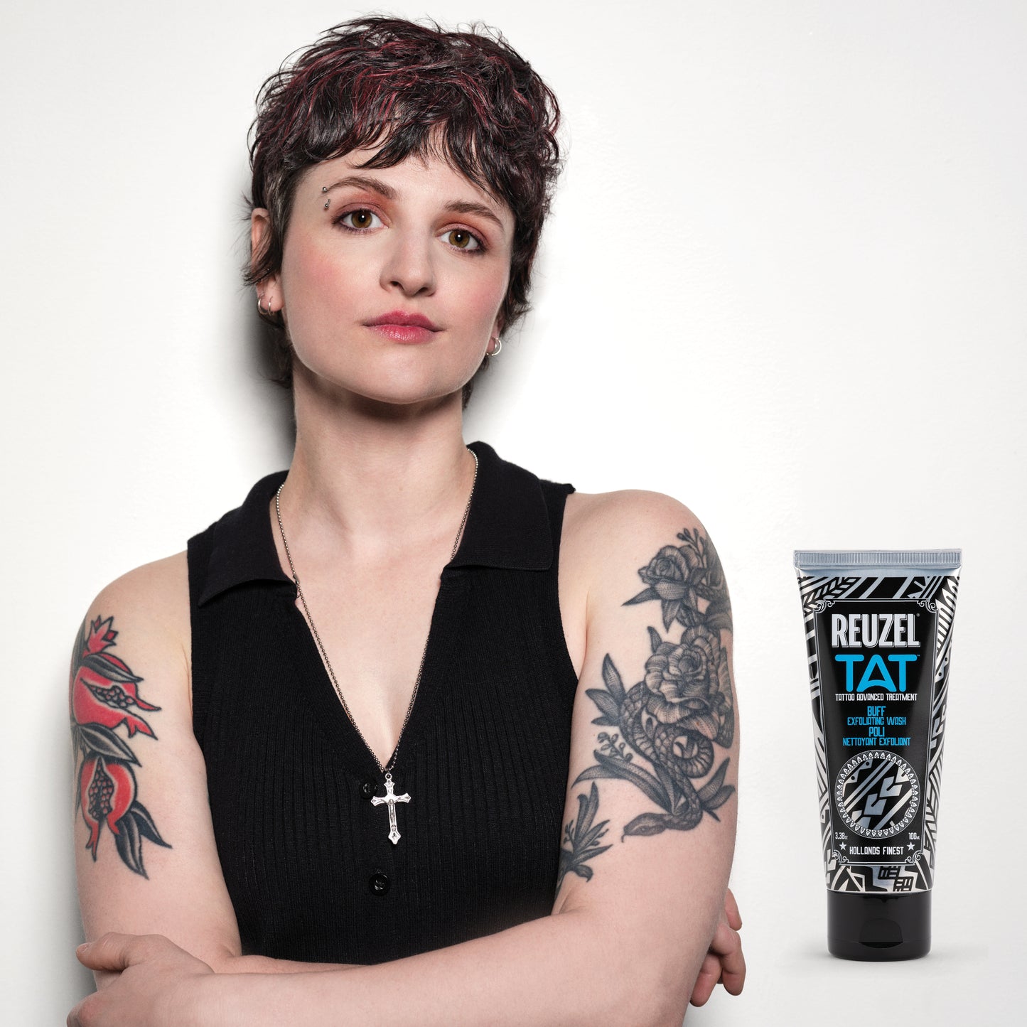 Woman with vibrant tattoos used with REUZEL TAT Buff Exfoliating Wash