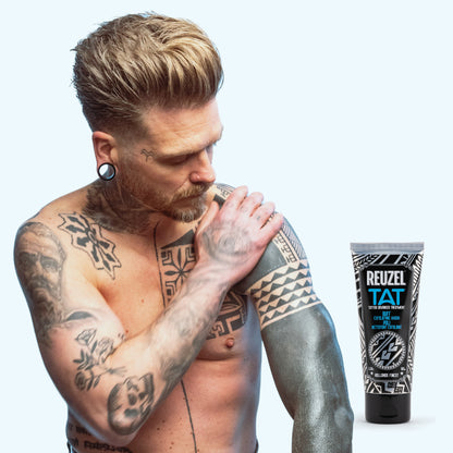 Man with vibrant tattoos used with REUZEL TAT Buff Exfoliating Wash