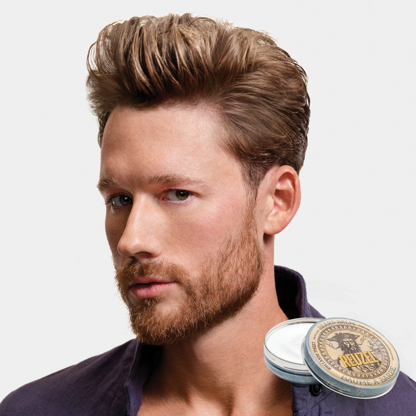 Man with brown hair and beard styled with REUZEL beard balm 