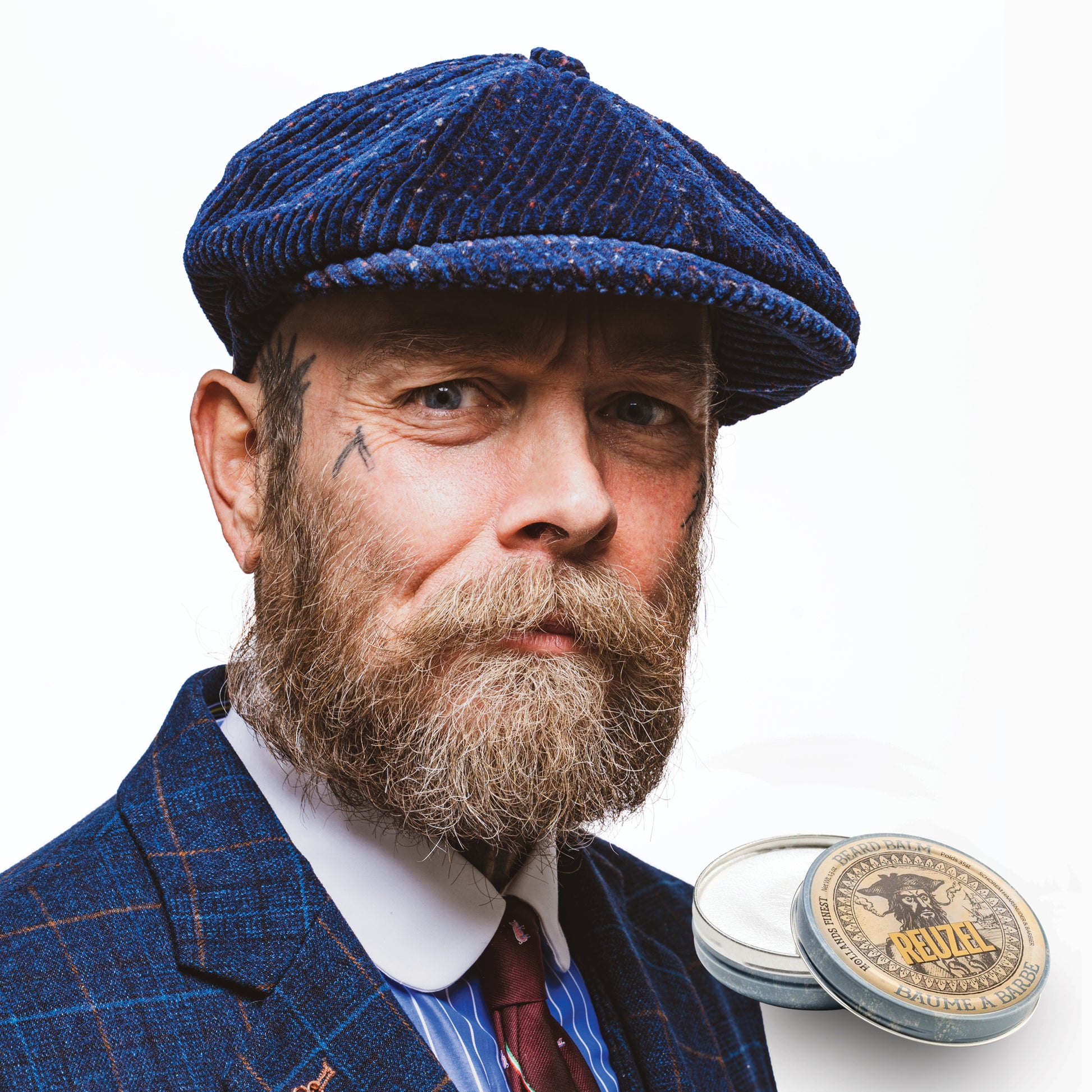 Man with brown hair and beard styled with REUZEL beard balm 