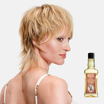 Woman with blonde hair styled with REUZEL Daily Shampoo