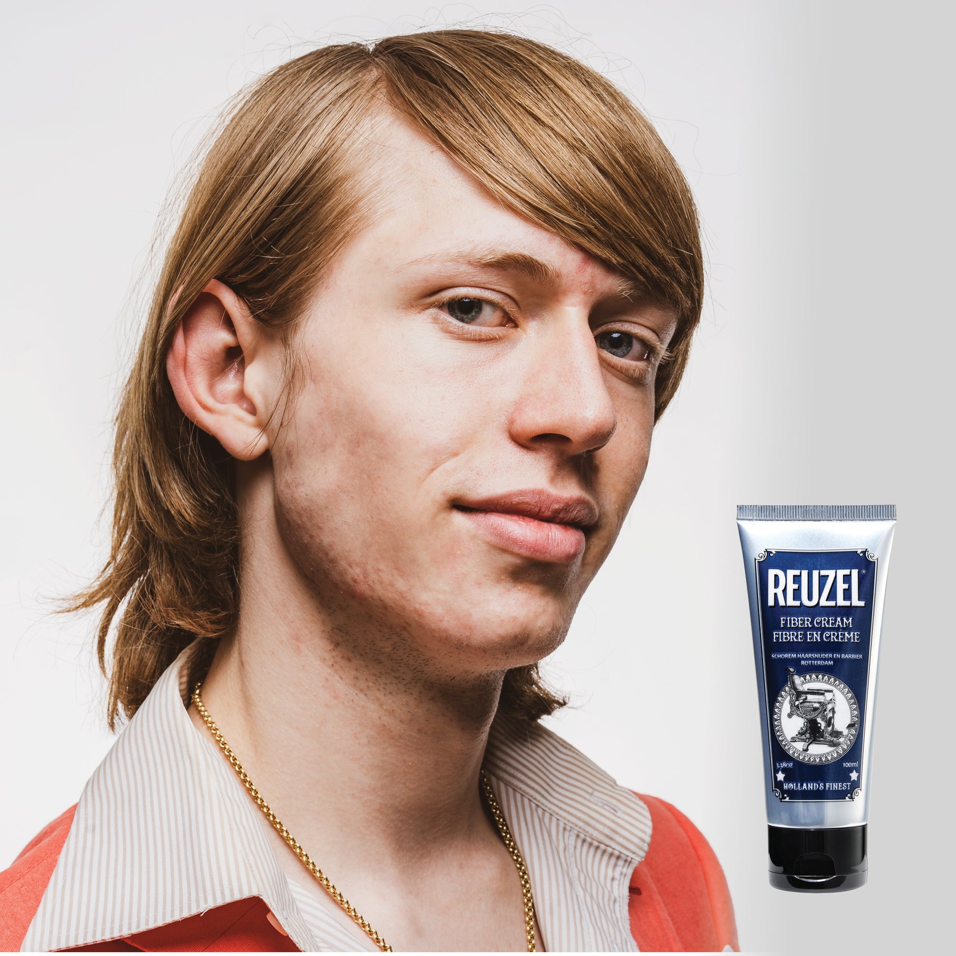Man with brown hair styled with REUZEL Fiber Cream