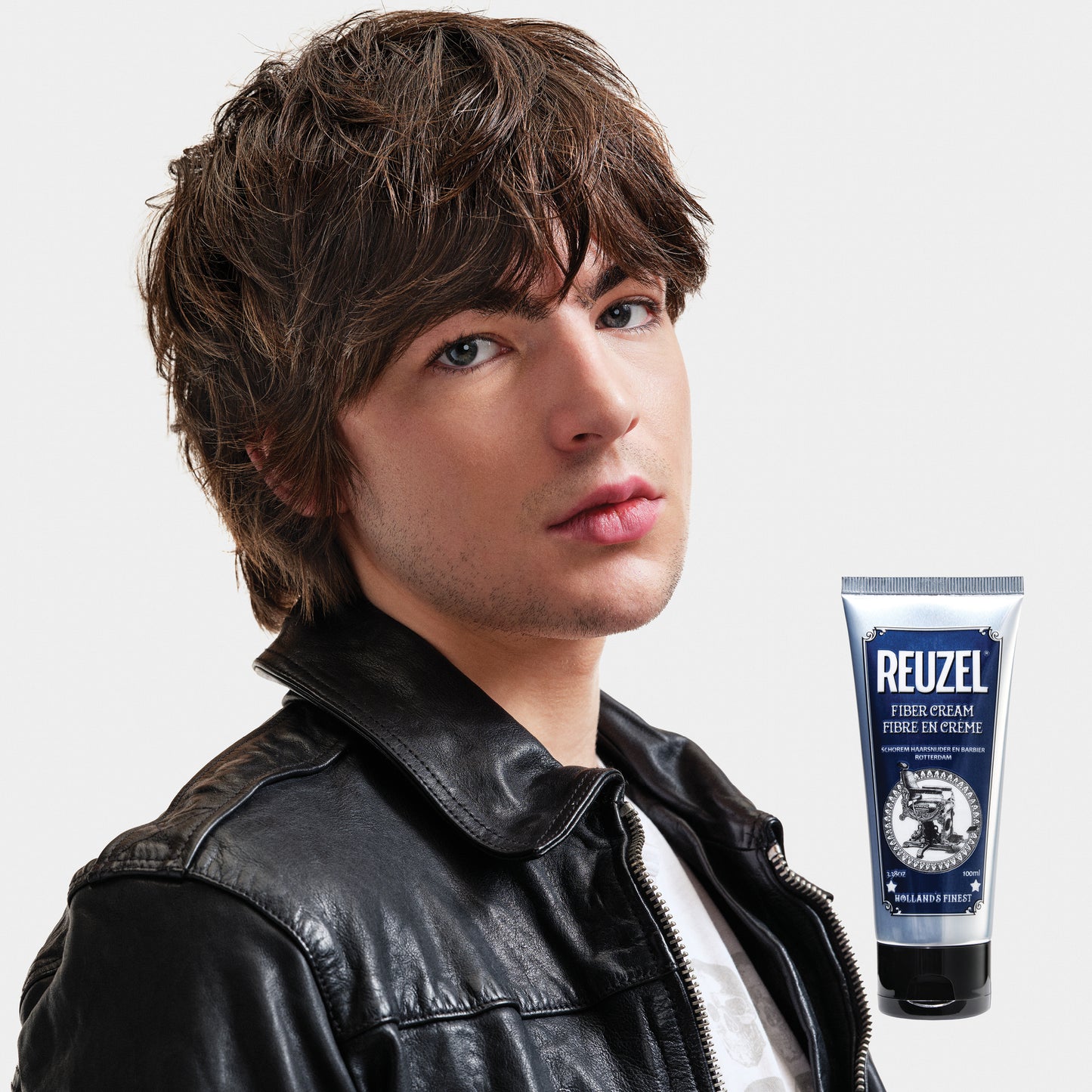 Man with brown hair styled with REUZEL Fiber Cream