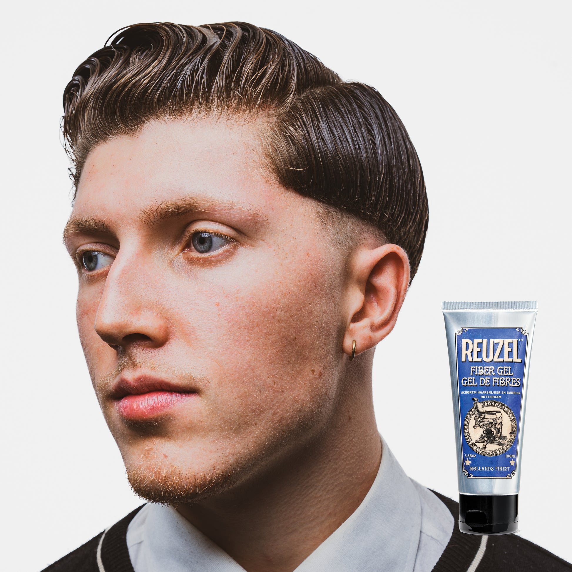 Man with brown hair styled with REUZEL Fiber Gel