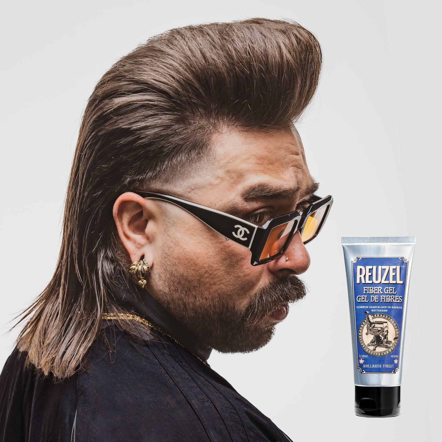 Man with brown hair styled with REUZEL Fiber Gel