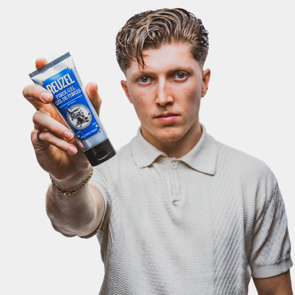 Man with brown hair styled with REUZEL Fiber Gel