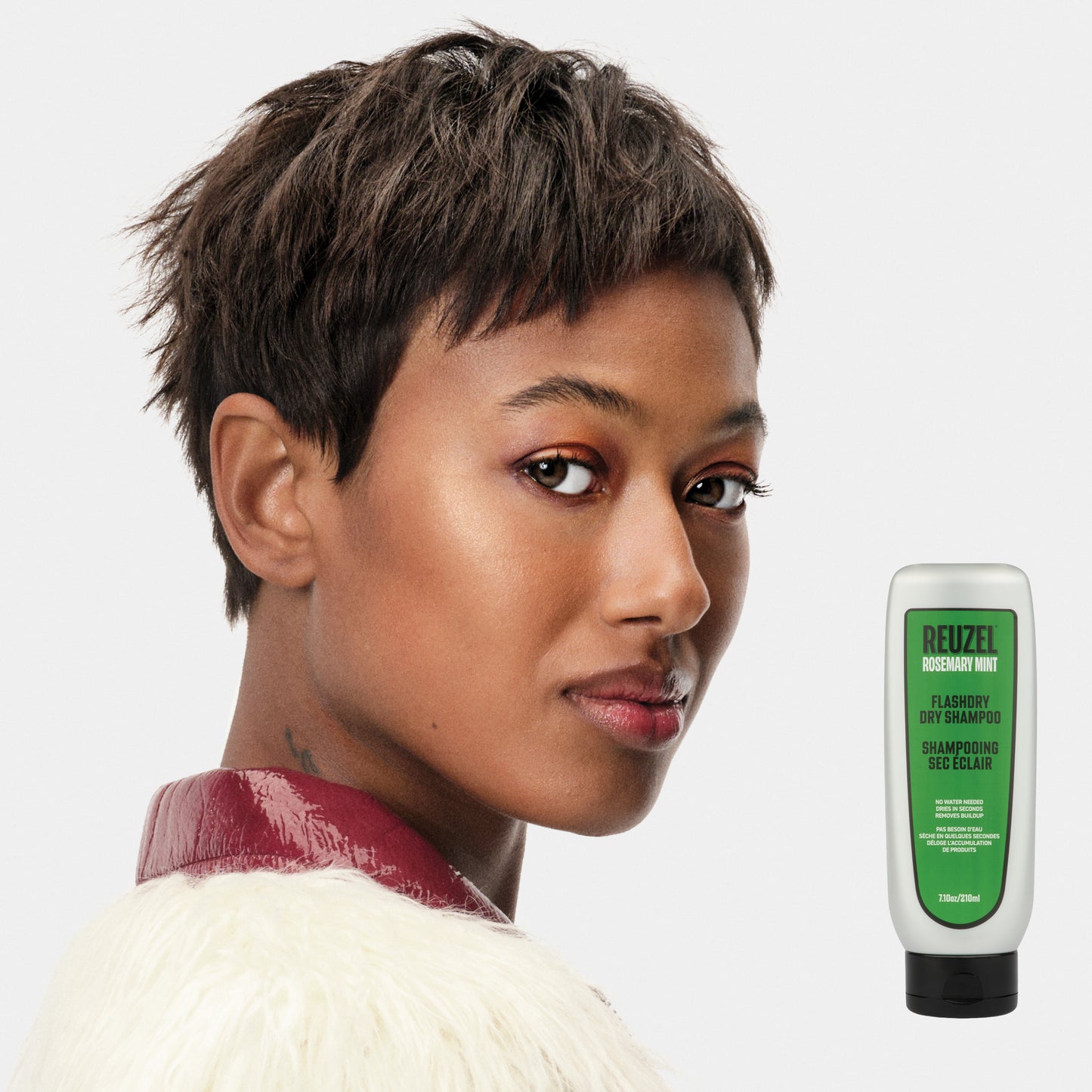 Woman with brown hair styled with REUZEL Rosemary Mint Flashdry Dry Shampoo