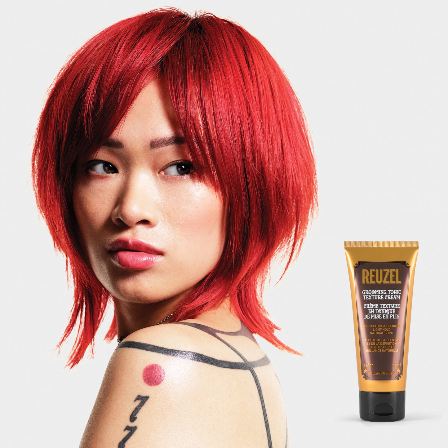Woman with red hair styled with  REUZEL Grooming Tonic Texture Cream 