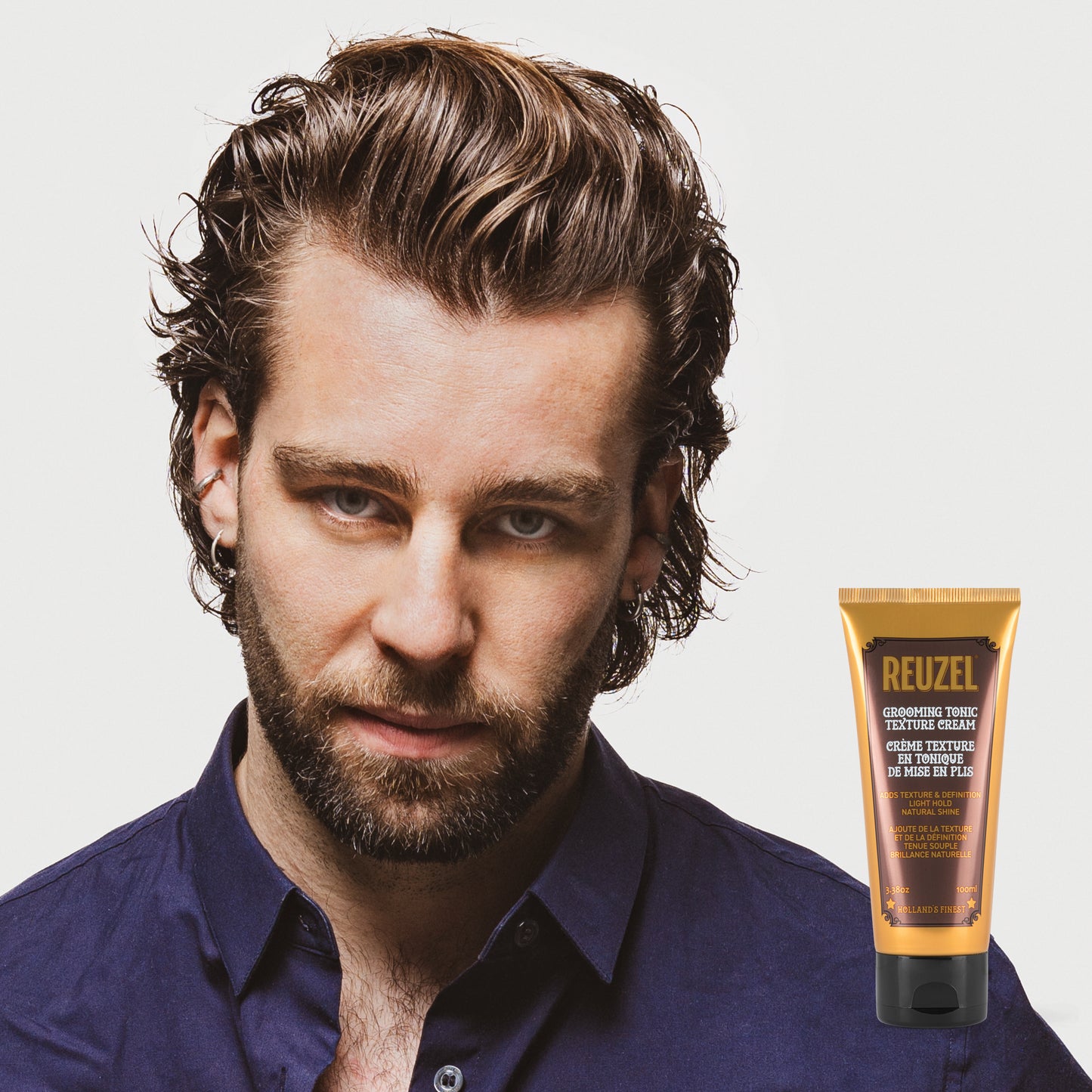 man with brown hair styled with  REUZEL Grooming Tonic Texture Cream 