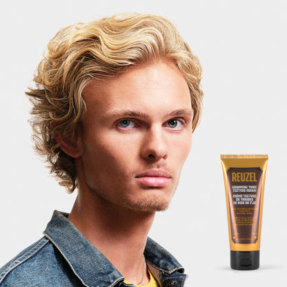 man with blonde hair styled with  REUZEL Grooming Tonic Texture Cream 