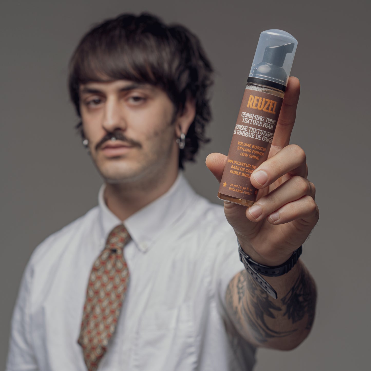 Man with Brown hair styled with REUZEL Grooming Texture Foam