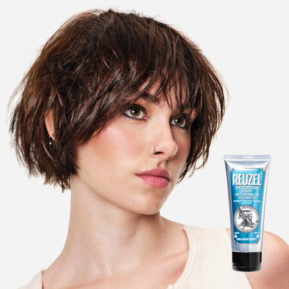 Woman with brown hair styled with REUZEL Grooming Cream