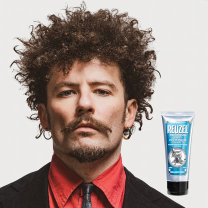 Man with brown curly textured hair styled with REUZEL Grooming Cream
