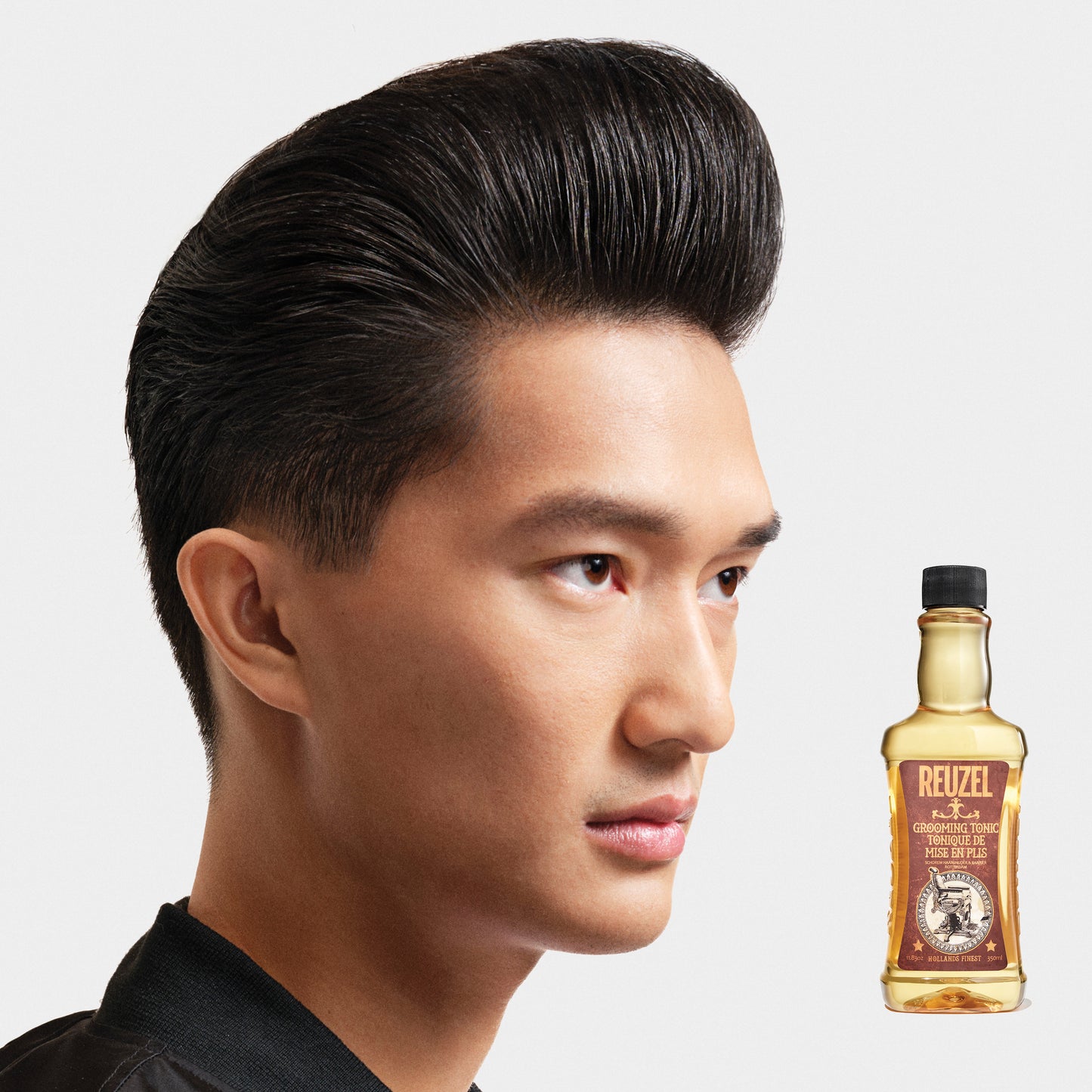 Man with brown hair styled with REUZEL Grooming Tonic