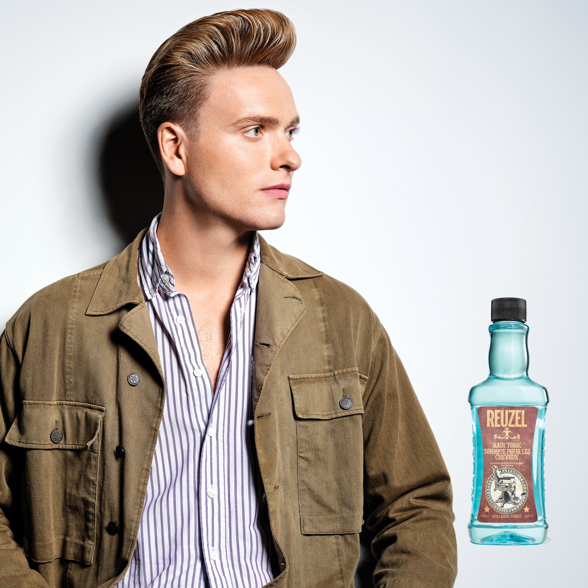 Man with blonde hair styled with REUZEL Hair Tonic