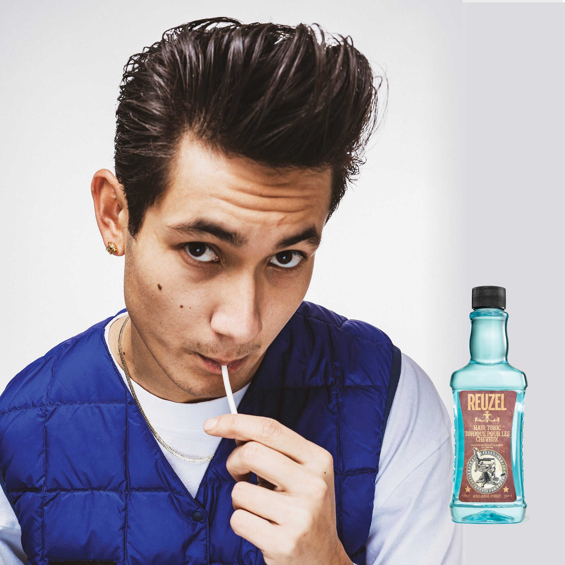 Man with brown hair styled with REUZEL Hair Tonic