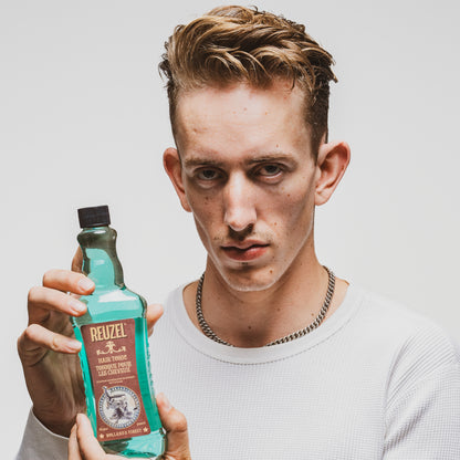 Man with brown hair styled with REUZEL Hair Tonic