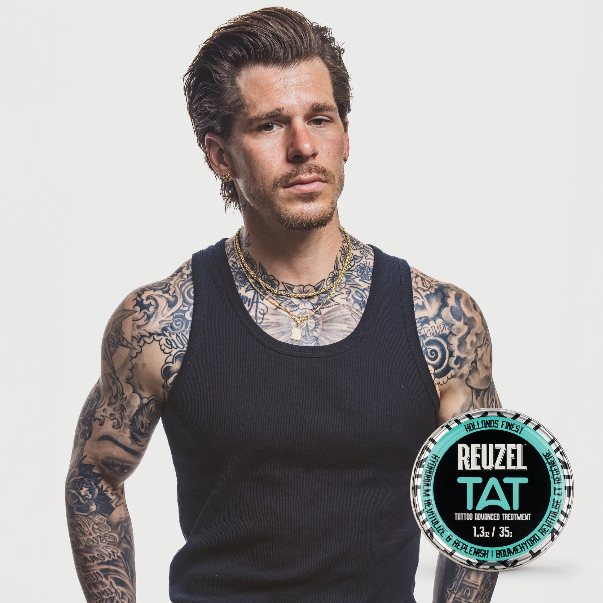 Man with vibrant tattoos used with REUZEL TAT Vivid Gel
