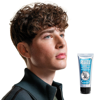 Man with brown hair styled with  REUZEL matte styling paste 