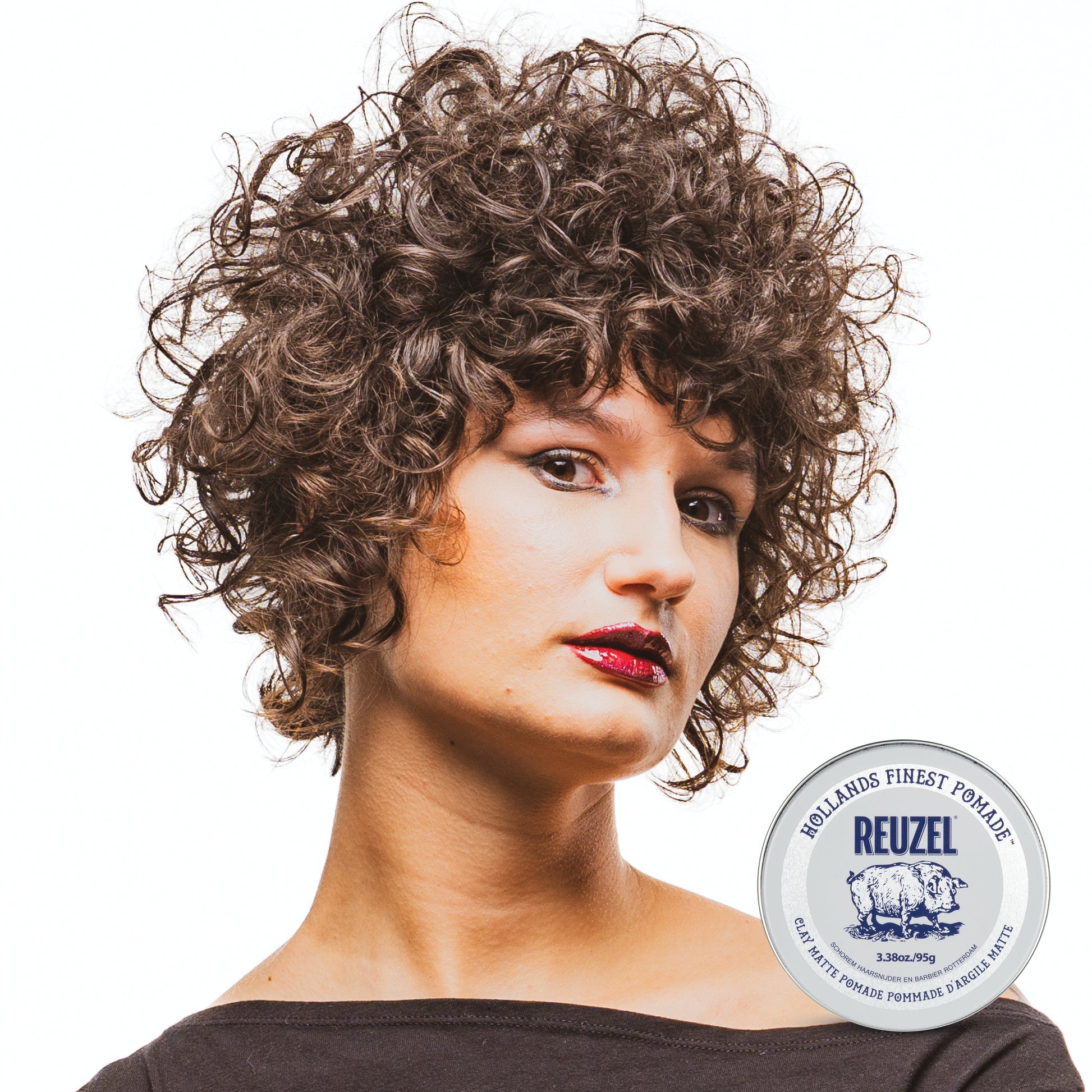 Woman with brown curly hair styled with REUZEL Clay Matte Pomade