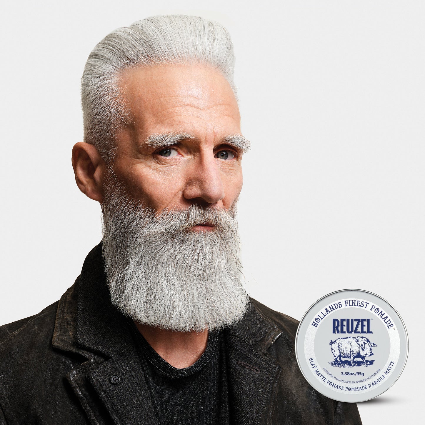 Man with grey hair styled with REUZEL Clay Matte Pomade