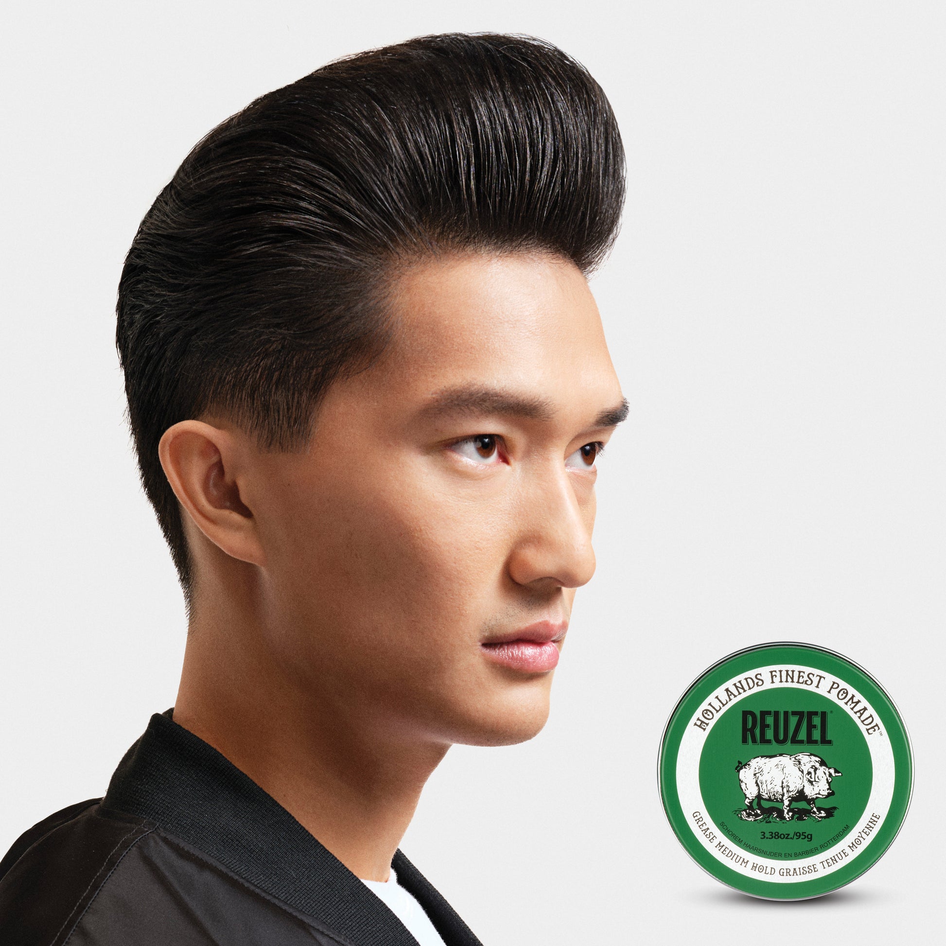 Man with brown hair styled with REUZEL grease medium hold pomade.