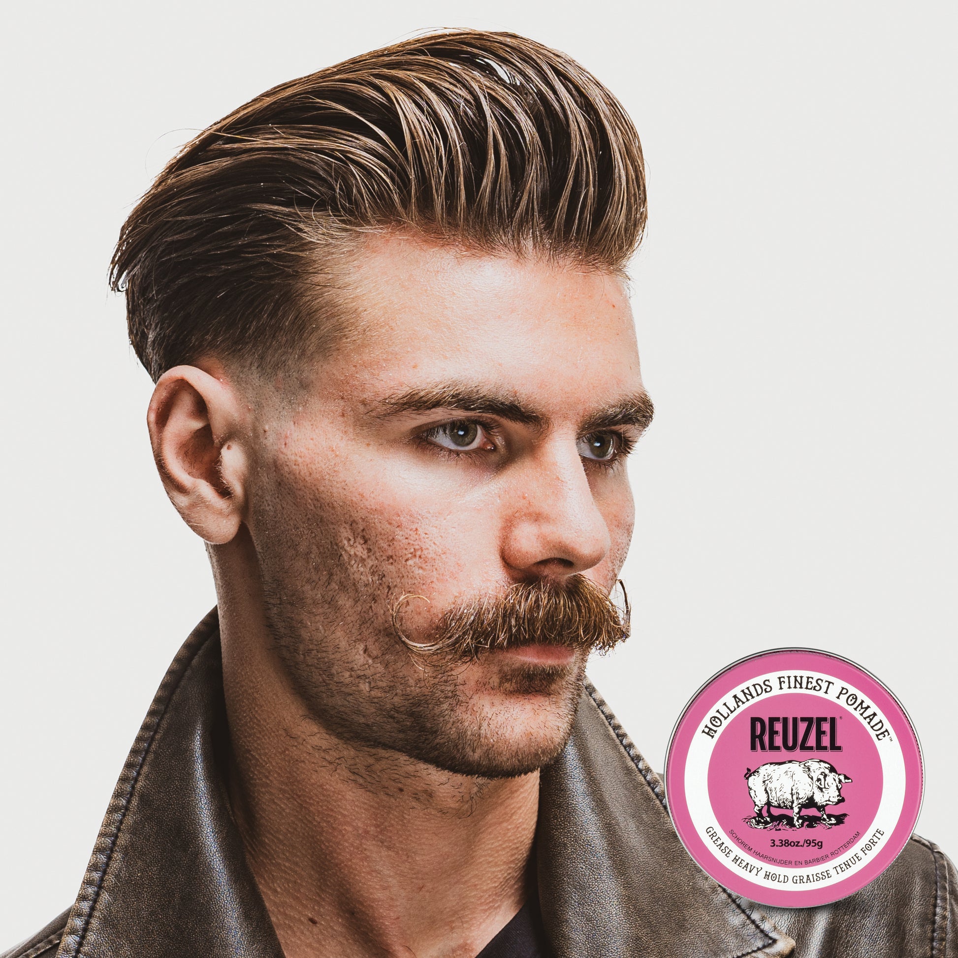 Man with brown hair styled with REUZEL Pink Grease Heavy Pomade