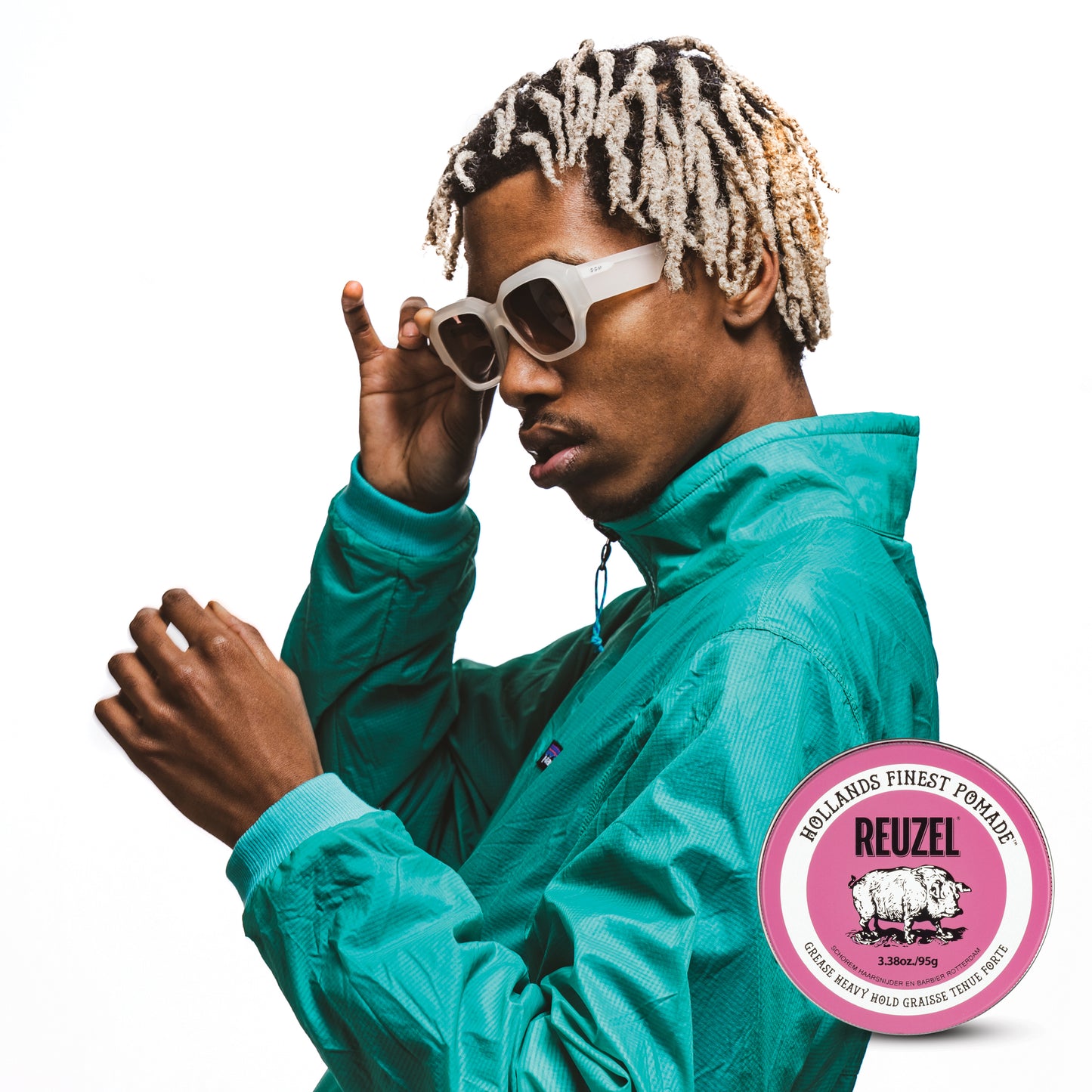 Man with curly textured hair styled with REUZEL pink grease heavy pomade.