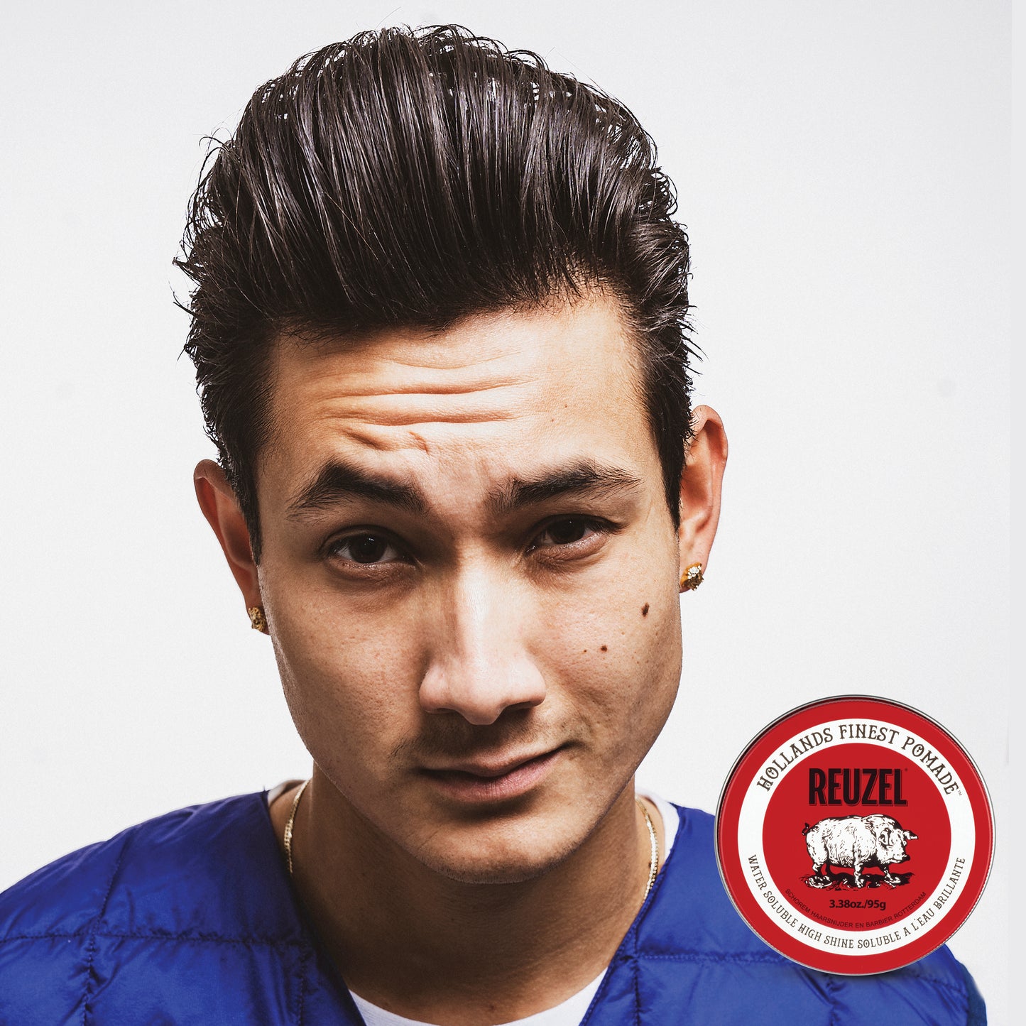 Man with brown hair styled with REUZEL Red Water-Soluble High Shine Pomade