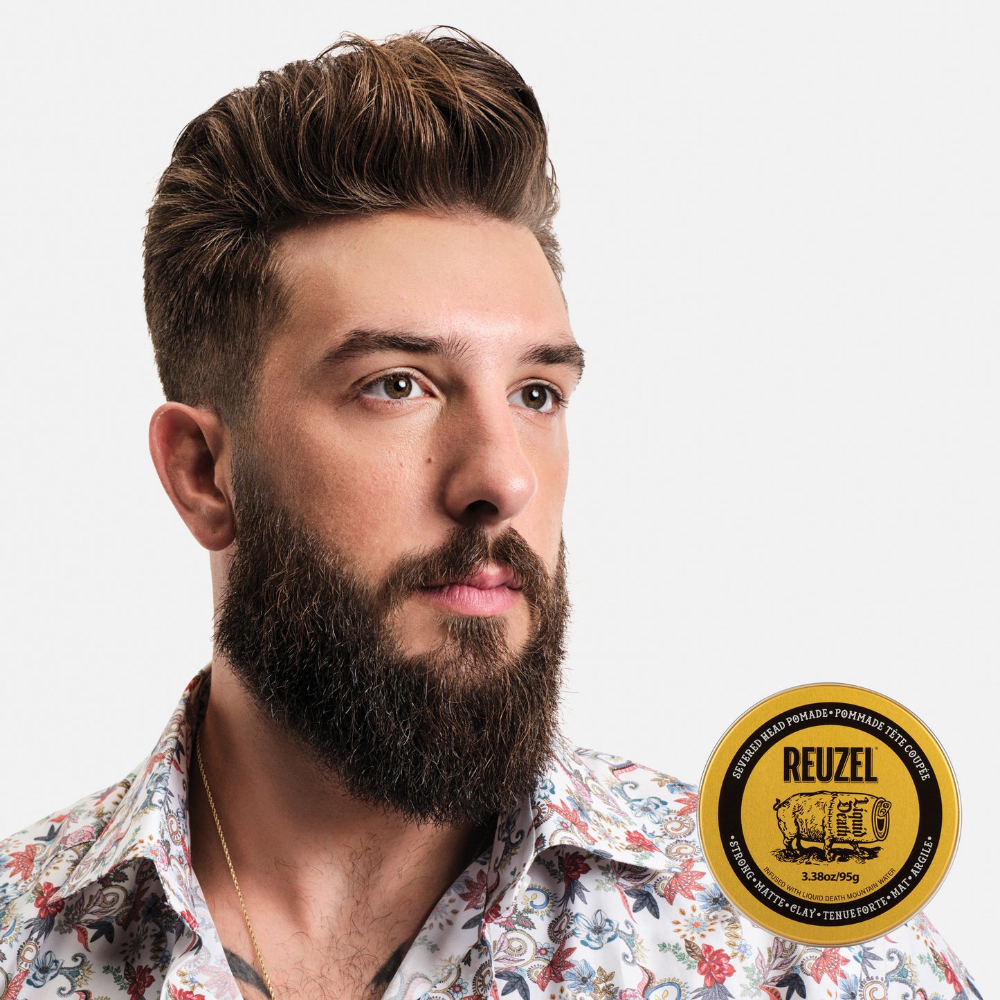 Man with brown hair styled with REUZEL Severed Head Strong Hold Matte Clay Pomade