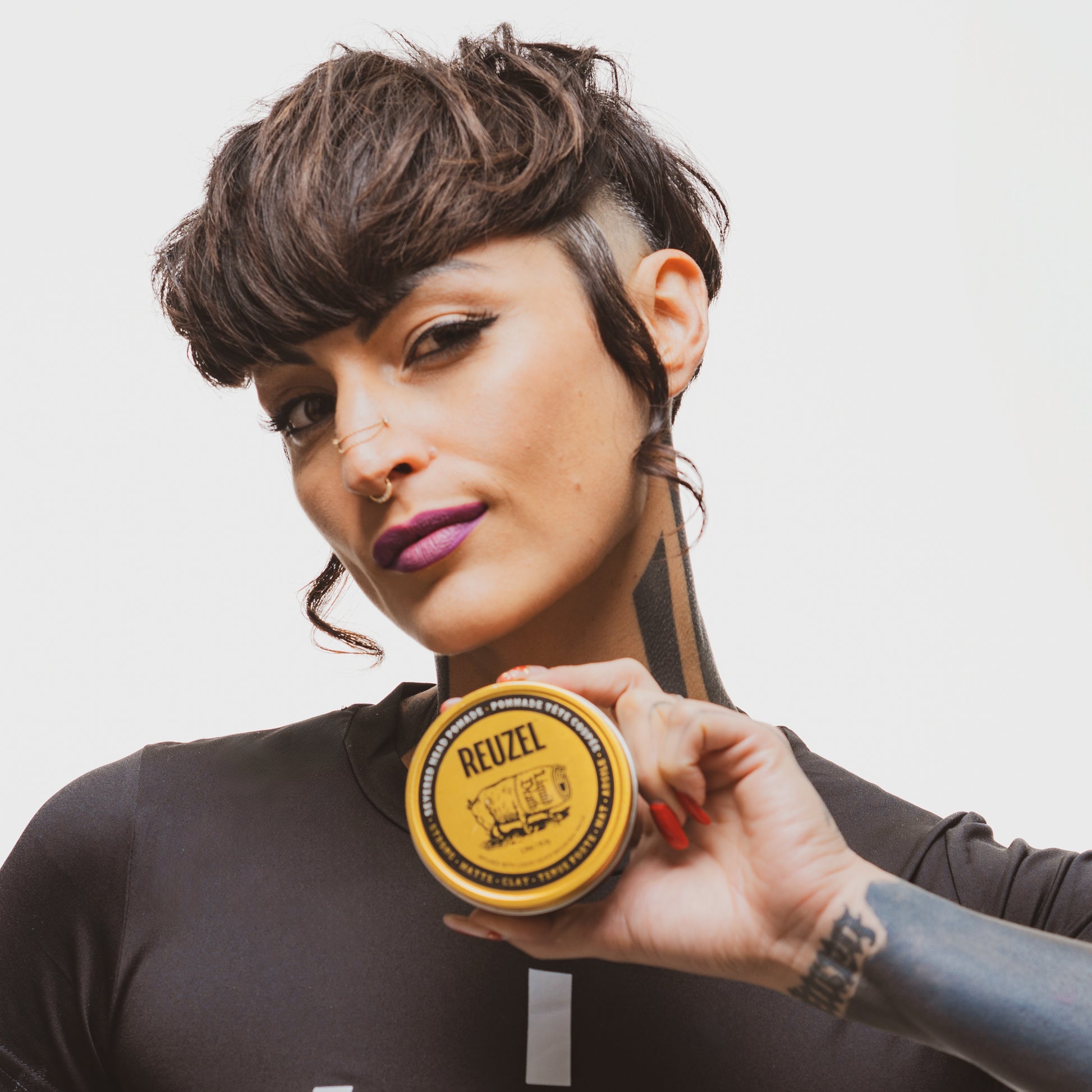 Woman's hair styled with REUZEL Severed Head Strong Hold Matte Clay Pomade