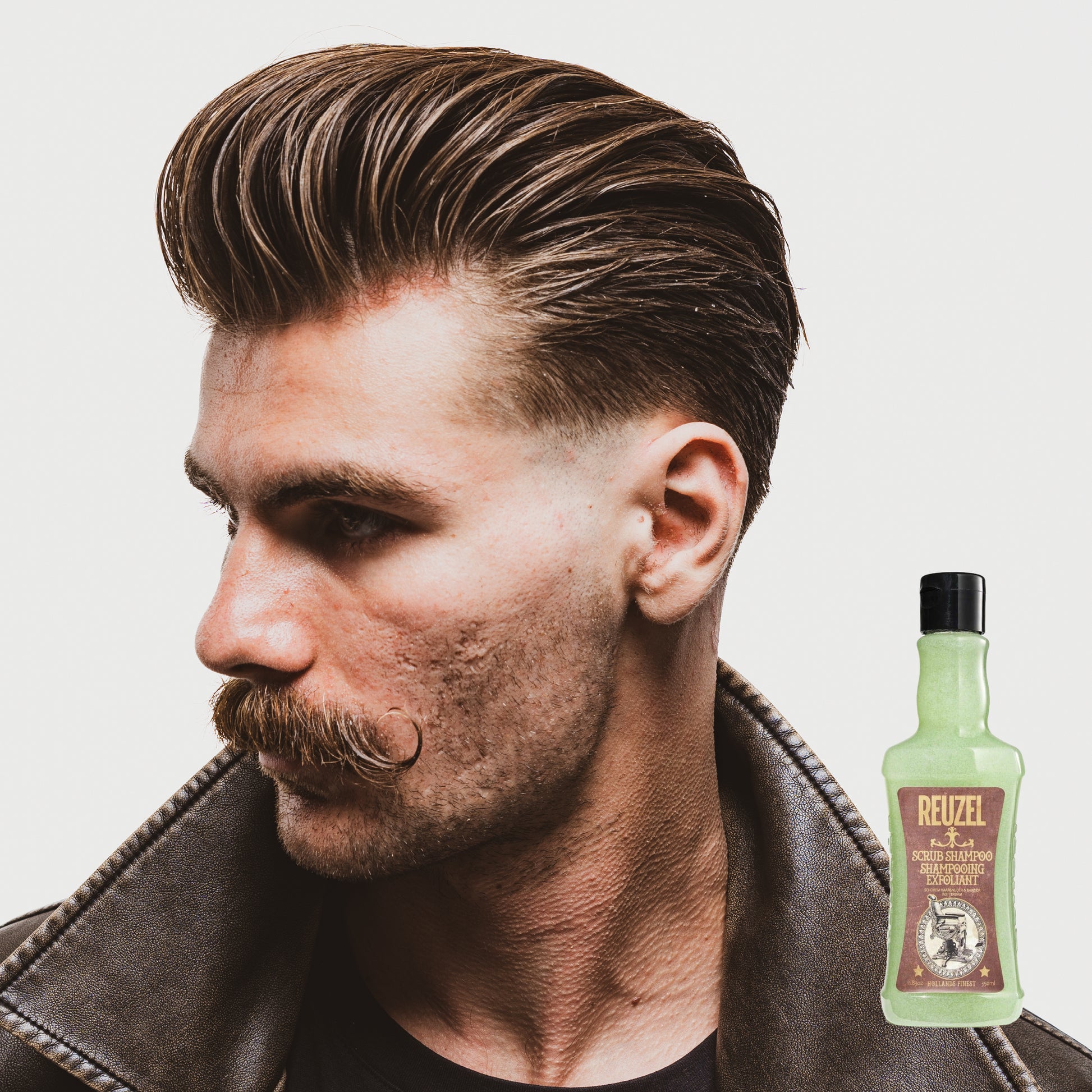 Man with brown hair styled with REUZEL Scrub Shampoo