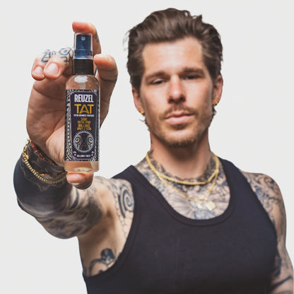 Man with vibrant shiny tattoos used with REUZEL TAT SHINE Spray Tattoo Aftercare Products