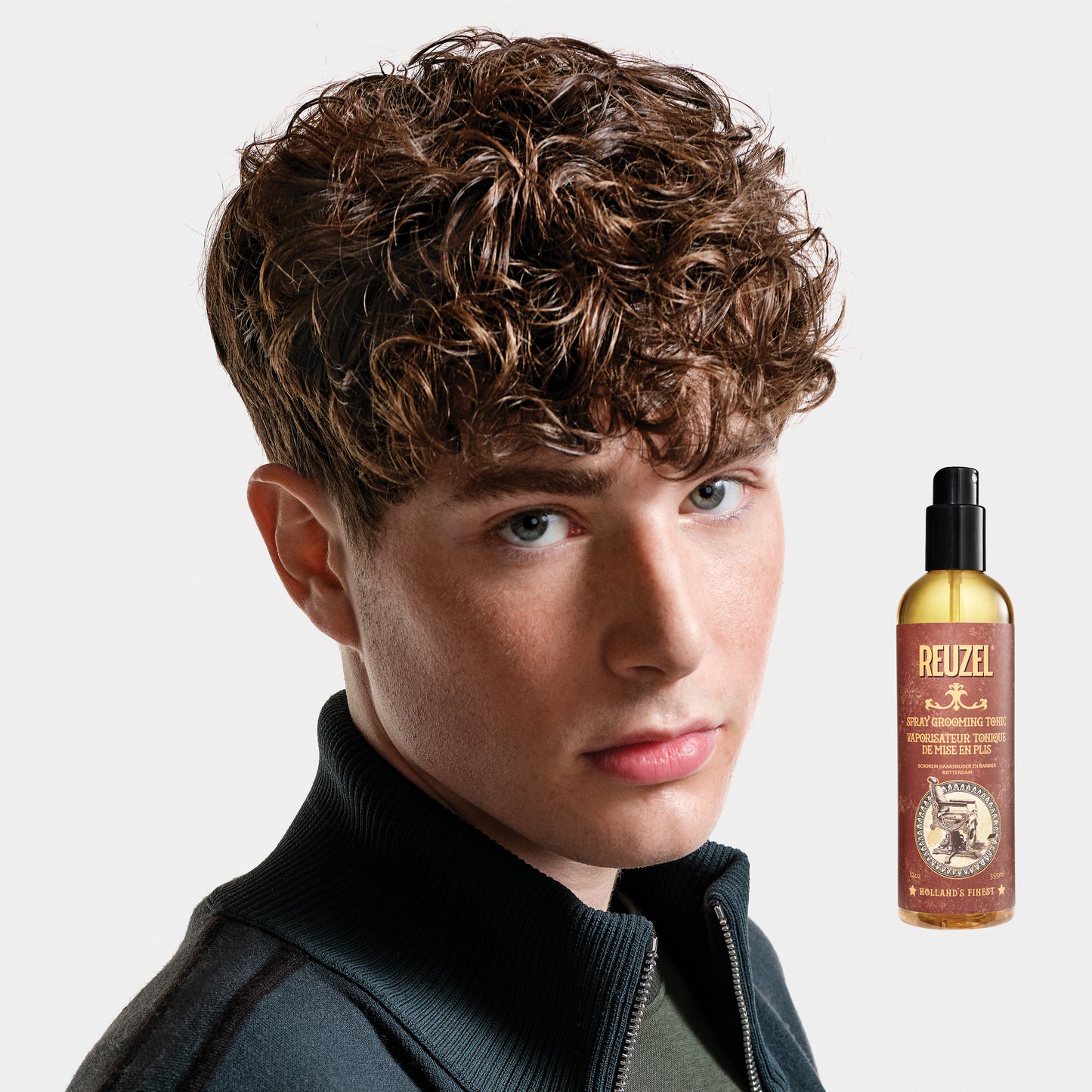 Man with brown hair styled with REUZEL Spray Grooming Tonic