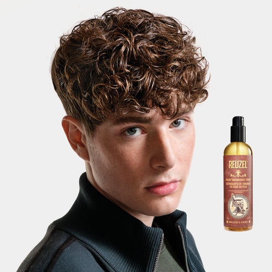 Man with brown hair styled with REUZEL Spray Grooming Tonic